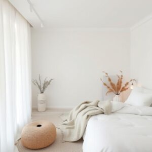 White minimalist bedroom with cozy textures and soft lighting